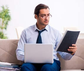 Young male employee working from house
