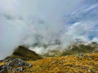 Landscape of Fagaras Mountains shrouded in fog.
