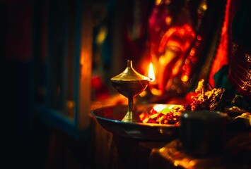 Oil Lamp on fire infront of Hindu god - obrazy, fototapety, plakaty