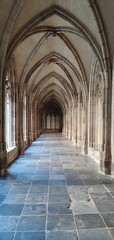 Empty, grand hallway featuring multiple ornamental arches