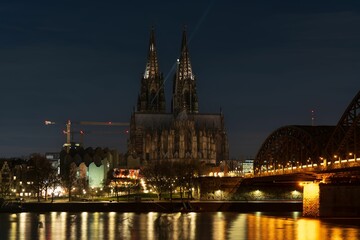 A breathtaking view of Cologne Cathedral and the Rhine River illuminated by the night sky