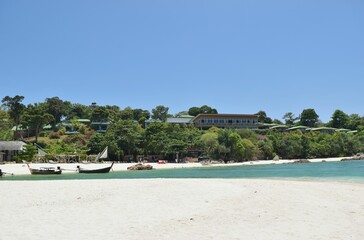 Fototapeta na wymiar Sandy beach with boats on Thai island.