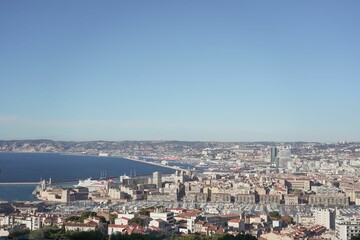 Fototapeta na wymiar Blue sky over sea and cityscape of Marseille, France captured from Notre dame de lagarde cathedral
