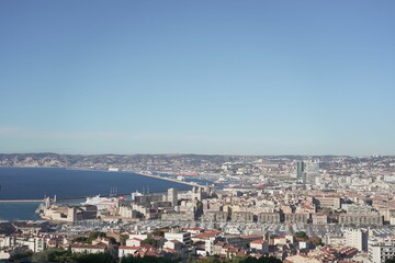 Obraz premium Blue sky over sea and cityscape of Marseille, France captured from Notre dame de lagarde cathedral