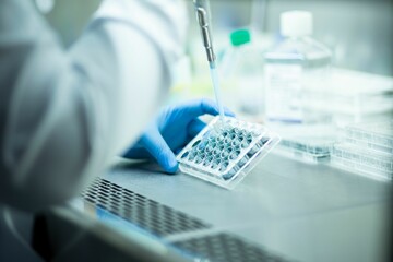 Chemist wearing protective gloves conducting a scientific experiment in a laboratory