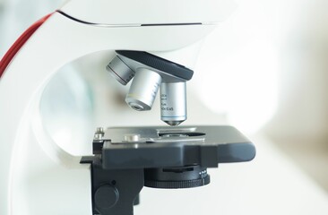 Closeup of a white microscope in a laboratory setting