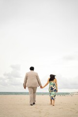 Fototapeta na wymiar Closeup of a loving couple embracing on a beach, enjoying a romantic moment together