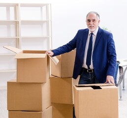 Aged businessman moving to new workplace