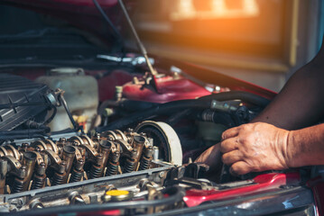 Close up Man hands fixing Car machinery vehicle mechanical service. Mechanic man hands repairing...