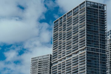 a view of a sky scraper in front of the buildings