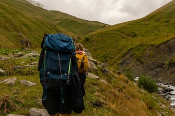 Ascending a mountainous terrain with a large hiking backpack in tow