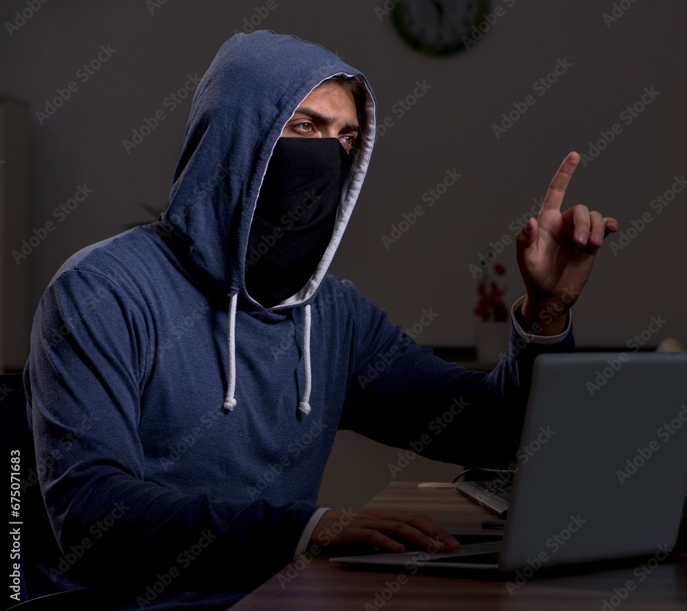 Poster male hacker hacking security firewall late in office