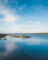 a lake surrounded by trees on top of a lush green hillside