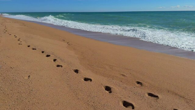 walking on the beach, footprints in the sand Mediterranean sea, turquoise blue Costa Brava