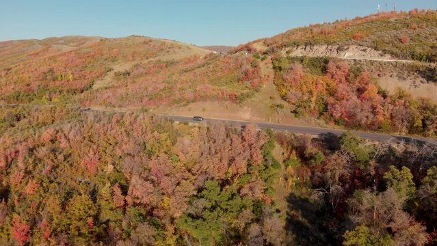 Rapid aerial push in of cars on Emigration Canyon Road during fall Utah, USA.