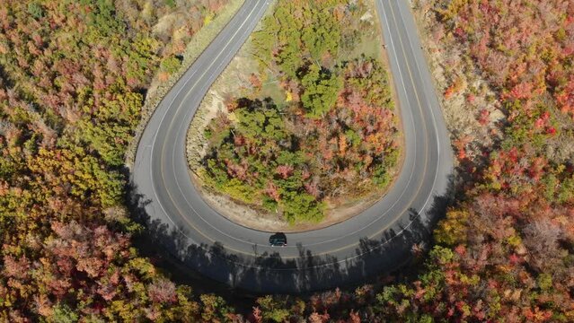 Top down aerial of cars on Emigration Canyon road loop during fall Utah, USA.