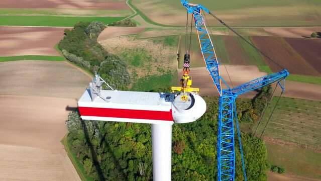 Installation Of Wind Turbine Head - Wind Turbine Under Construction - drone shot