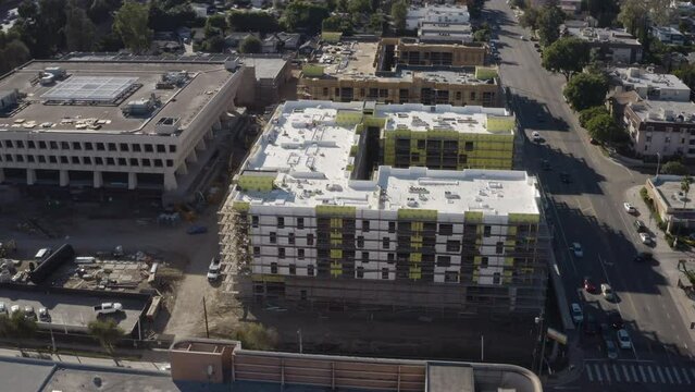 4K aerial shot of new construction of a large apartment building in Sherman Oaks California with the 101 freeway in the background.
