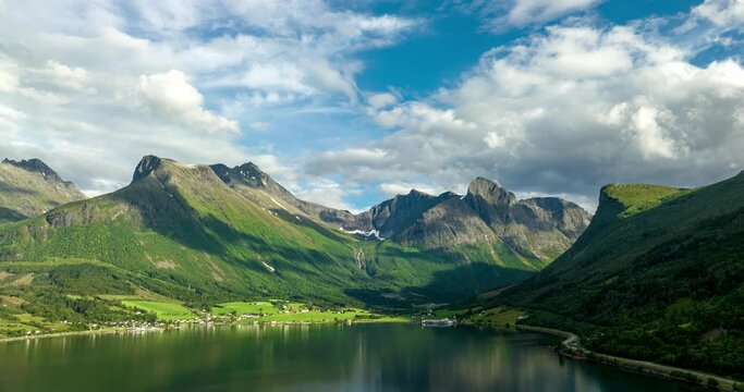 Stunning skyline of clouds in motion and blue with settlement below