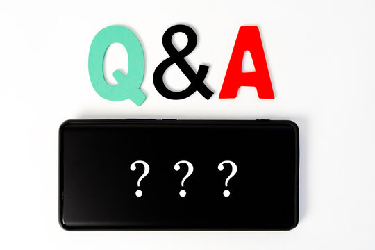 Questions And Answers Q&A Session Concept With Hands Holding Modern Tablet Or Smartphone.