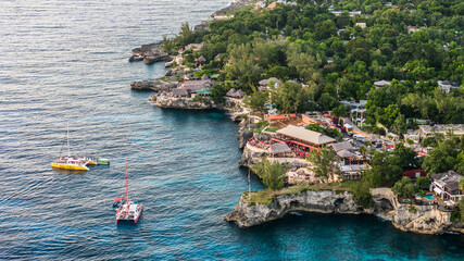 Negril, Jamaica, aerial landscape view of area around the famous Rick's Cafe in Negril, with boats...