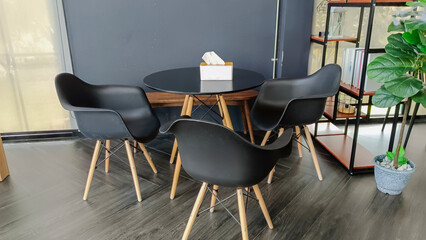 chairs black colors and empty wooden table on wood floor in cafe