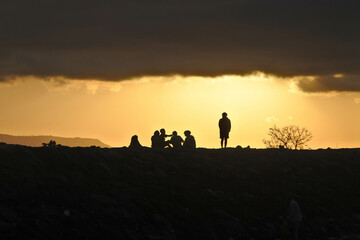 Fototapeta na wymiar Human silhouette on a beach at sunrise.
