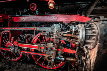A close up of an old steam train locomotive engine
