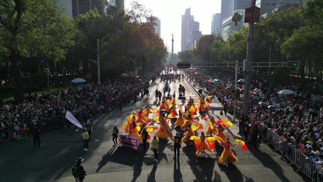 Aerial view of Mexico city paseo de la reforma avenue celebratin a dia de muertos parade on a sunny day, cdmx day of the death parade