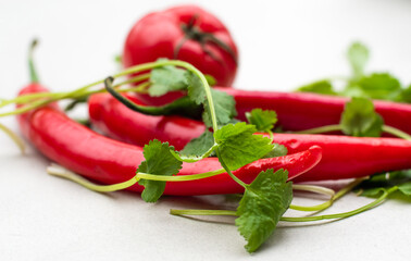 A group of red peppers and tomatoes decorated with corianders