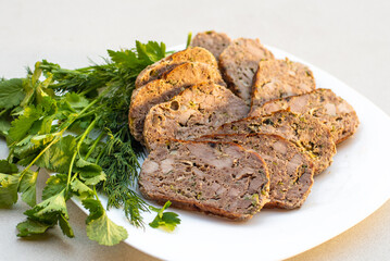 A plate of grilled steak meat decorated with  vegetables and green salads
