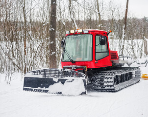 A snowcat grooms a road for the ski tracks in the city park