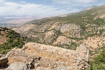 Fototapeta na wymiar View of the adjacent gorge from the watchtower in the medieval fortress of Nimrod - Qalaat al-Subeiba, located near the border with Syria and Lebanon in the Golan Heights, in northern Israel