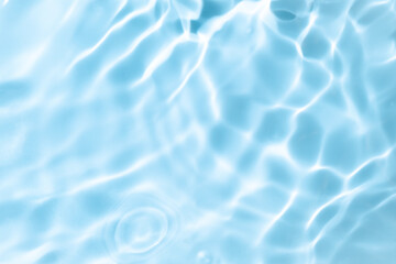 Natural background of water in summer. Blue surface. Clear water with ripples and splashes. water waves in sunlight The water surface has waves.