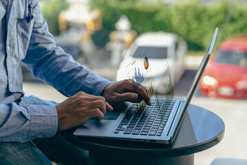 Young Asian businessman working with laptop, checking graphs, company budget reports, production control. Operational inspection cost plus price Close-up pictures