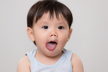 Asian cute baby boy show his tongue