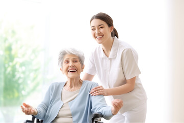 happiness elderly woman with young beautiful nurse in a wheel chair