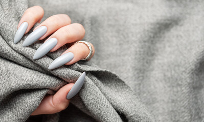Grey manicure nails with a grey scarf