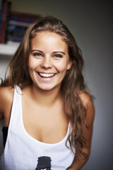 Happy, woman and portrait with laughing and modern casual clothing in a house with confidence. Youth, teen and relax young female person with gen z fashion style and funny joke with a teenager