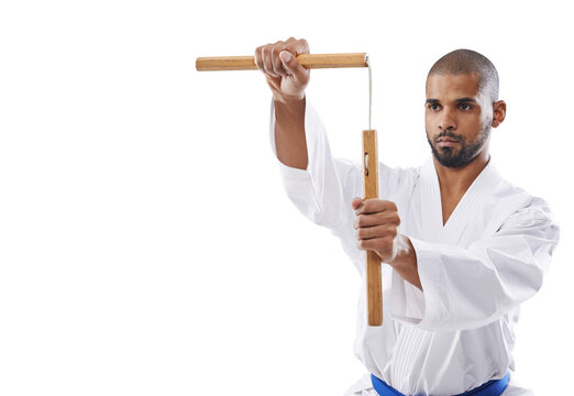 Karate, discipline and a man training with nunchucks isolated on a transparent background for self defense. Fitness, sports or weapon with a young athlete on PNG to practice for a combat competition
