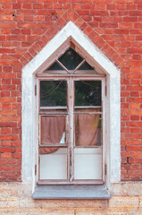 Stained glass window in an old brick house