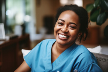 Smiling woman wearing blue scrub suit is seated comfortably on couch. This image can be used to depict healthcare professional or medical worker in relaxed setting. - obrazy, fototapety, plakaty