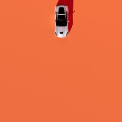 sports car with up angle with orange background wall