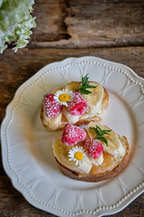 Sweet fruit sandwich made from loaf, peanut butter, banana and raspberries.