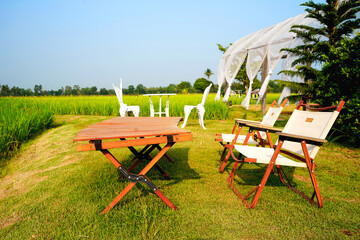 The wooden arch is decorated with white cloth to help block the sun. And it's a minimal style photo...