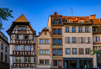 Fototapeta na wymiar Ornate traditional half timbered houses with steep roofs in the old town of Grande Ile, the historic center of Strasbourg, Alsace, France at sunset