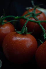 Tomato bunch isolated on solid black background Top view