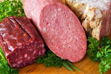 Sausages, meat and lard with herbs. A set of meat products.