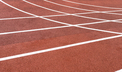 Red treadmill with the lines at the stadium. Treadmill lane on sport field. Running track on the stadium. Red treadmill in sport field. Running track