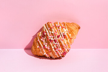 croissant with hearts on a pink background